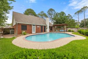 a backyard with a pool and a house at My Amazing Bay House & Pool in Houston