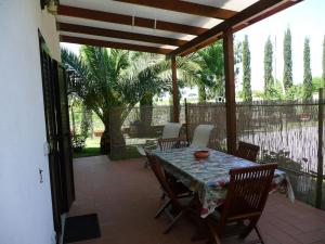 a patio with a table and chairs and a fence at Trilocale in MAREMMA in Orbetello