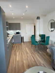 a kitchen and a living room with a table and chairs at 3 Bedroom Apartment with Balcony in Bishops Stortford