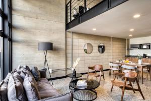 a living room with a couch and a table at Downtown Loft by ULIV in Tijuana