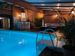 a house with a swimming pool at night at La Chamade in Montjoie-en-Couserans