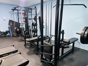 a gym with several rows of tread machines and weights at Apartamento Cuiabá - Luxxor Flat in Cuiabá