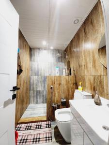 a bathroom with a shower and a toilet and a sink at Guest house in Lankaran
