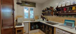 a kitchen with a sink and a counter top at Mis Tres Centenarios in El Puerto de Santa María