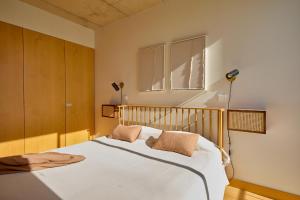 a bedroom with a white bed with two pillows at Oporto Maison Anselmo in Porto