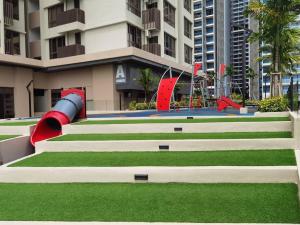 a group of stairs in a building with a playground at UWen Sylist 2BR Family Suite in Melaka