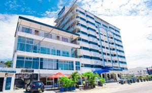 a building on a street with a car parked in front at Beau Fahy Nyali studio apartment in Mombasa