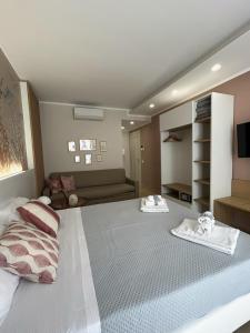 a bedroom with a large bed with towels on it at Memo - Mediterranean Emotions in San Vito lo Capo