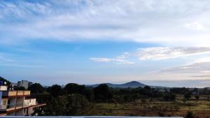 a view of a mountain in the distance at Ambient Homestay by NESTEASY in Nashik