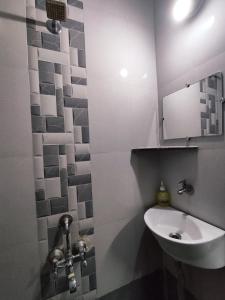 y baño con lavabo y espejo. en Ambient Homestay by NESTEASY en Nashik