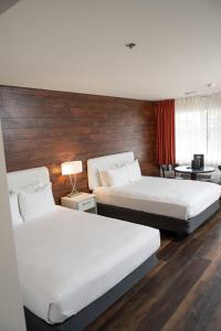 a hotel room with two beds and a window at Carson Valley Motor Lodge and Suites in Minden