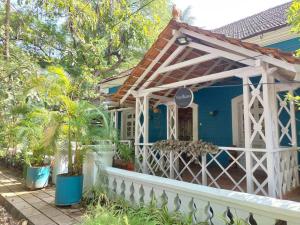 a blue house with a white fence in front of it at Stelliam's Luxury Heritage Suite in Campal, Goa in Panaji