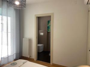 a room with a bathroom with a toilet and a window at Casa del Porto in Pesaro