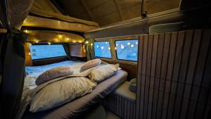 a small room with two beds and pillows in it at Unique 70s stay! Volkswagen T2 Campervan Dome in Castelldefels