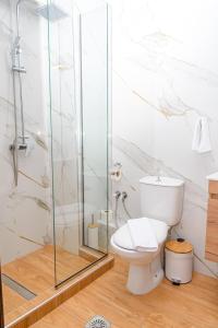 a bathroom with a toilet and a glass shower at Emi's House in Xanthi