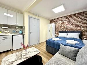 a bedroom with a bed and a brick wall at Golden Stay Boutique Hotel Taksim in Istanbul