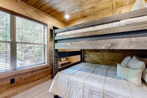 a bedroom with a bunk bed in a log cabin at Valley Creek Castle in Pigeon Forge +22 photos