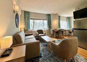 a living room with a couch and a table at The GEM Museum Suites in Evanston