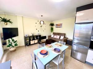 a living room with a table and a couch at Apartamento Playa Blanca in Corcubión