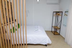 a bedroom with a crib with a white bed at Emi's House in Xanthi