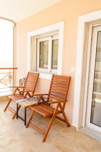 two chairs and a table on a balcony at Emi's House in Xanthi