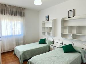 a room with two beds and a window at Casa Sear-Bordóns in Sear
