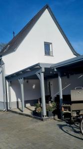 a large white house with a covered porch at Ferienwohnung Nietwerder in Nietwerder