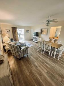 a living room with a couch and a table and chairs at Lighthouse Point Rental 8B in Tybee Island