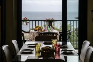 a dining table with a view of the ocean at L'alba di Santa Cesarea in Santa Cesarea Terme