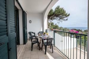 a patio with a table and chairs on a balcony at L'alba di Santa Cesarea in Santa Cesarea Terme