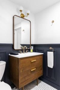 a bathroom with a sink and a mirror at King Bed , DTWN, 50 in Roku TV , Fiber Internet, Room # 203 in Bangor