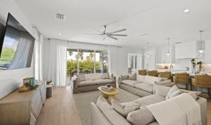 un soggiorno con divani e tavolo e una cucina di From Dusk 'Til Dune, Gorgeous 5 beds, 5,5 Baths Home on the Canal and steps away from the beach! ad Anna Maria