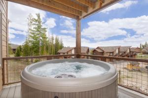 a hot tub on the balcony of a house at Rendezvous 47 Lookout Point in Fraser