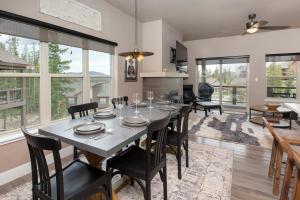 a dining room with a table and chairs and windows at Rendezvous 47 Lookout Point in Fraser +31 photos