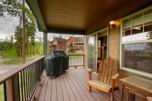 a porch with a wooden bench and a chair at 45 Reunion Court - Rendezvous in Fraser