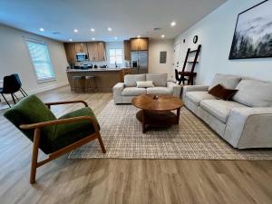 a living room with a couch and a table at Montgomery Modern Luxury Stays in Montgomery
