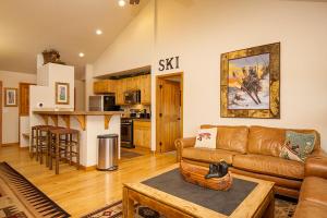 a living room with a couch and a kitchen at 45 Reunion Court - Rendezvous in Fraser