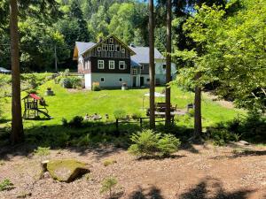 a large house with a playground in front of it at Chalupa Sněhurka in Polubný