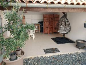 a room with potted plants on the floor of a house at Petite maison de ville in Miramont-de-Guyenne +2 photos