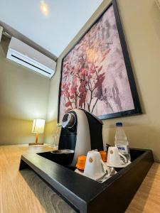 a hotel room with a sink and a painting on the wall at Pousada Papiro Boutique in Abraão