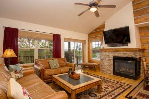 a living room with a couch and a fireplace at 45 Reunion Court - Rendezvous in Fraser