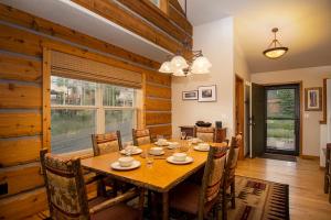 a dining room with a wooden table and chairs at 45 Reunion Court - Rendezvous in Fraser +29 photos