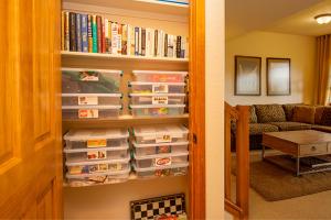 a book shelf filled with food trays in a living room at 45 Reunion Court - Rendezvous in Fraser