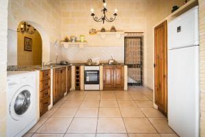 a large kitchen with a washer and dryer at 3 Bedroom Holiday Home with Private Pool and Views in Nadur