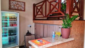 a kitchen with a counter with a drink refrigerator at Pousada Enseada da Vila in Cabo Frio