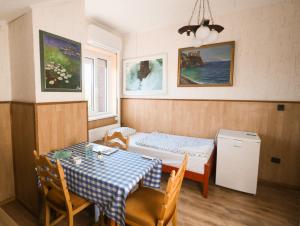 a room with a table and a bed and a table and chairs at Müller's 1 in Siófok