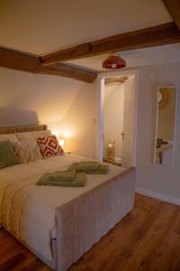 a bedroom with a large bed and a mirror at Countryside Loft in Bridgnorth in Bridgnorth
