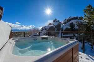 a hot tub on a balcony with snow covered mountains at 273 Fallen Rock in Tabernash