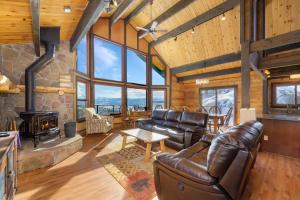 a living room with leather furniture and a fireplace at 273 Fallen Rock in Tabernash