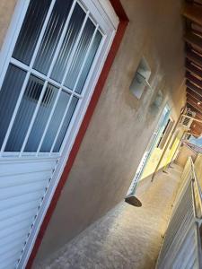 a stairway leading up to a building with windows at Suites do Rafa Ubatuba in Ubatuba